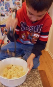 My grandson Georgie, furiously mashing the bananas with a potato masher. 