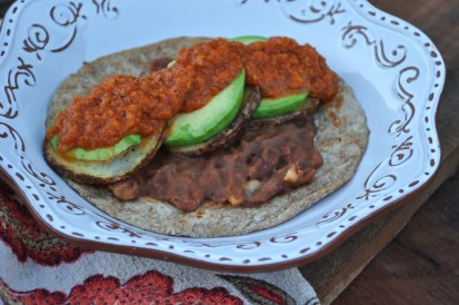 Potatoes Rancheros, a vegan twist on juevos rancheros. The creamy avocado and soft french fry-like potato rounds give the texture of a fried egg.